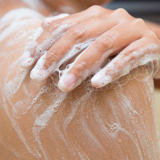 woman showering with Vanilla Coconut body wash shower gel